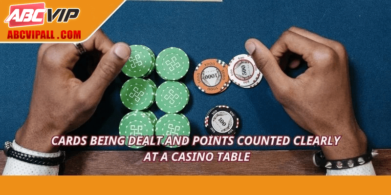 Cards being dealt and points counted clearly at a casino table