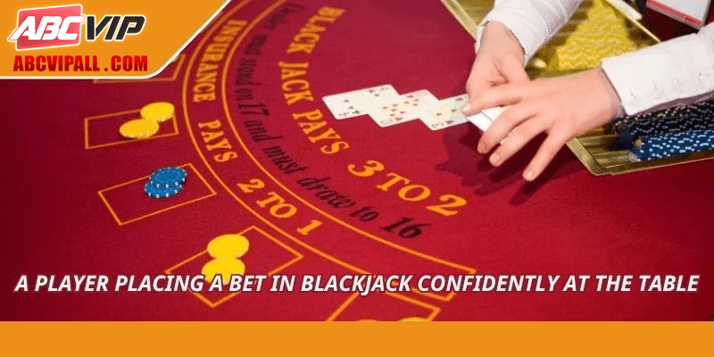 A player placing a bet in blackjack confidently at the table